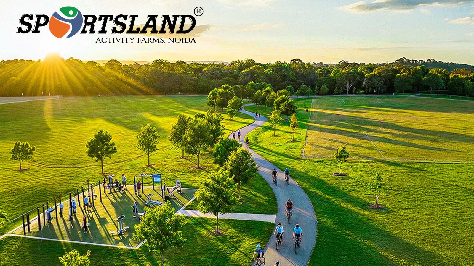Children playing in open green fields with families in a natural setting highlighting the importance of outdoor play spaces near Noida for physical activity and balanced urban living.