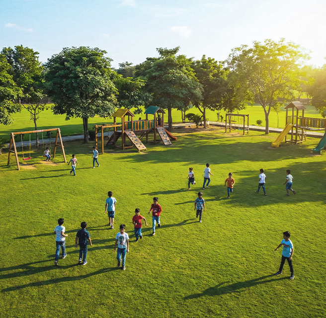 Children running freely together in open grassy field
